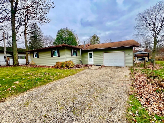 single story home featuring a garage and a front lawn