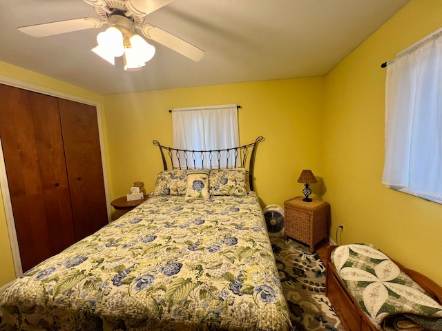 bedroom with ceiling fan and a closet