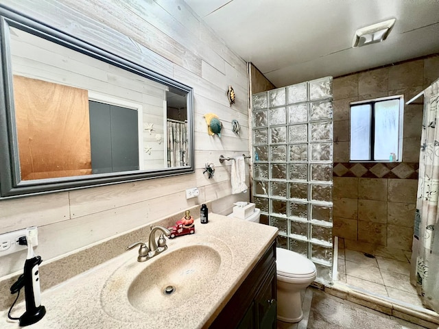 bathroom with wood walls, toilet, vanity, and walk in shower