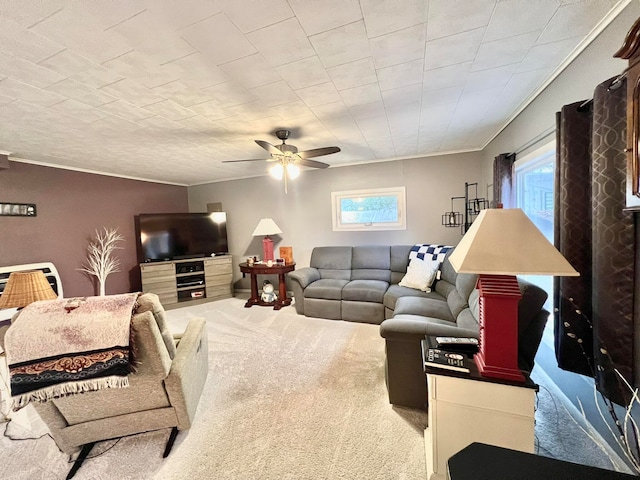 living room with carpet floors, a wealth of natural light, ornamental molding, and ceiling fan