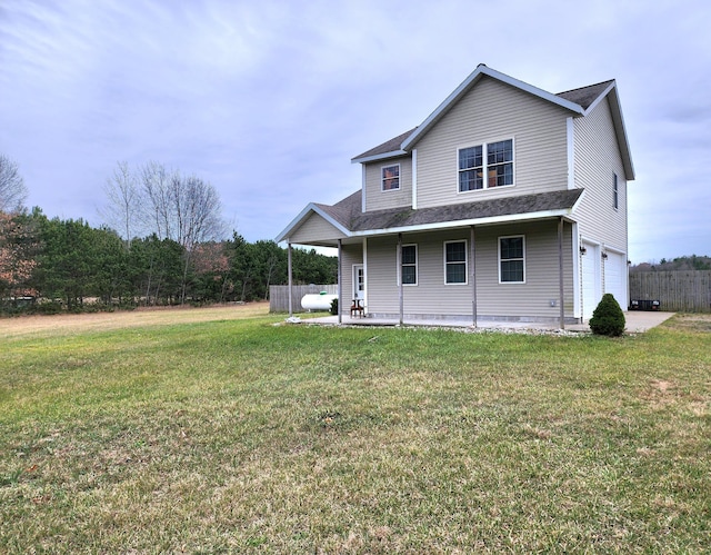 rear view of house with a garage and a lawn