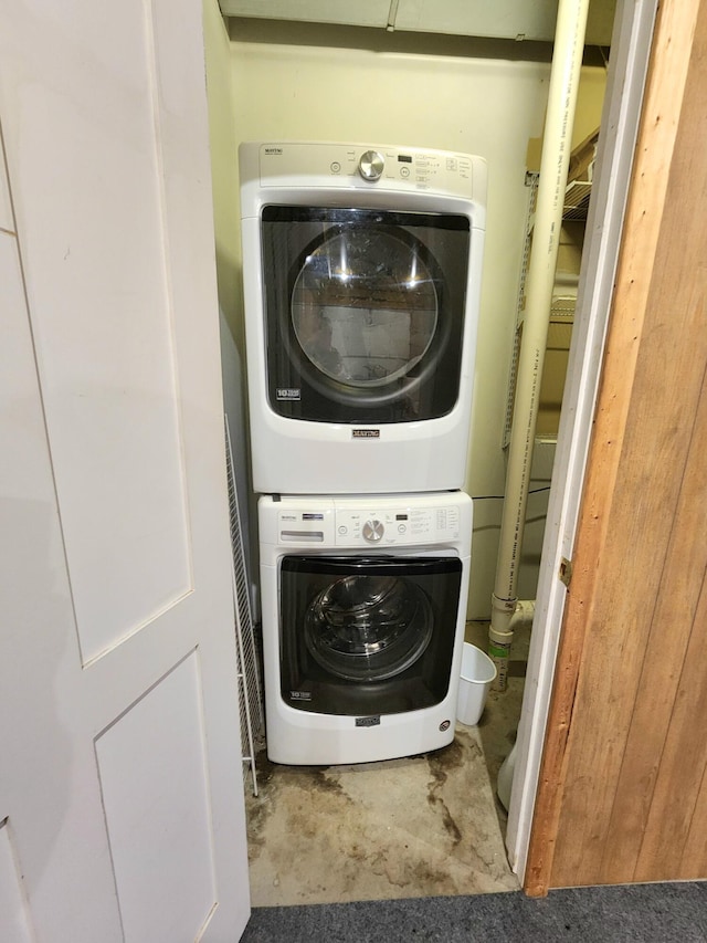 washroom featuring stacked washer / drying machine