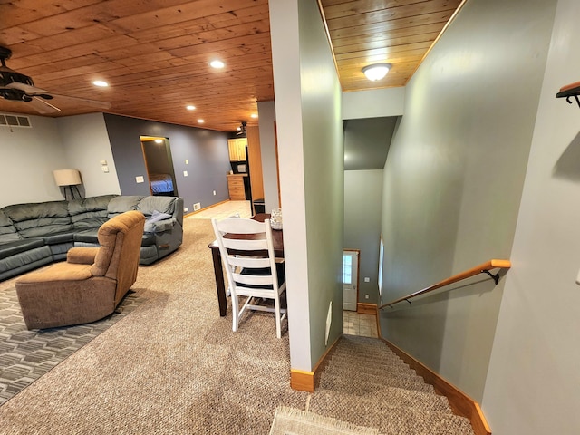 carpeted living room with wooden ceiling