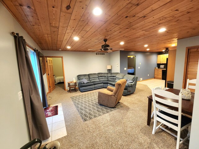 carpeted living room with ceiling fan and wooden ceiling