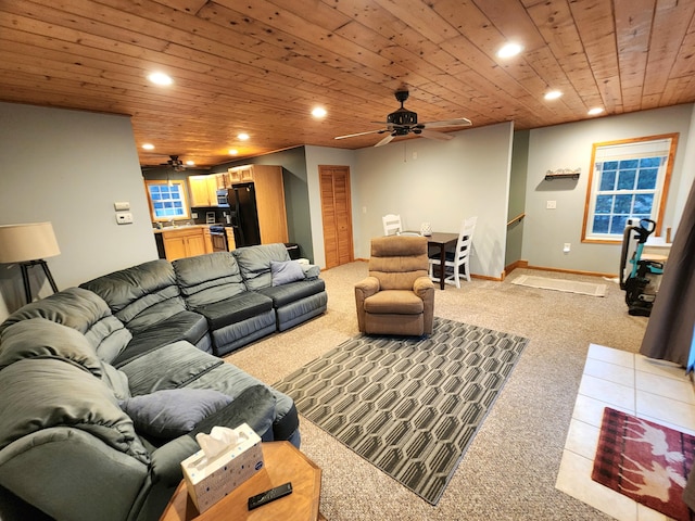 carpeted living room featuring ceiling fan and wood ceiling