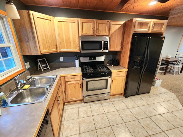 kitchen with wood ceiling, sink, light tile patterned floors, and black appliances