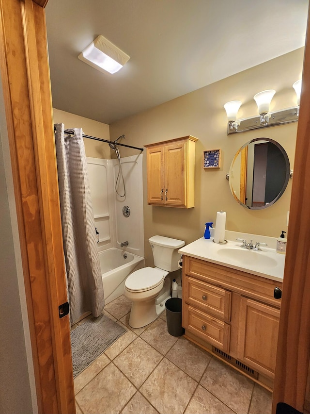 full bathroom featuring tile patterned flooring, shower / bath combo with shower curtain, vanity, and toilet