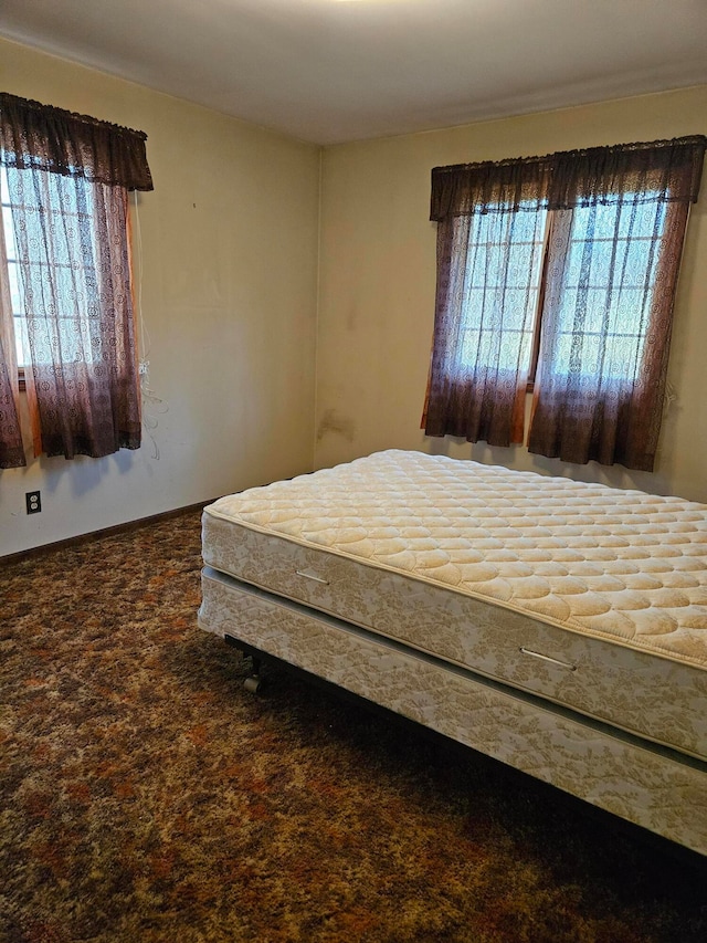 carpeted bedroom featuring multiple windows