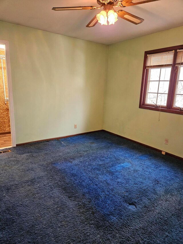 carpeted empty room with ceiling fan