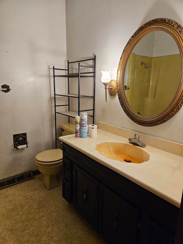 bathroom with a shower, vanity, and toilet