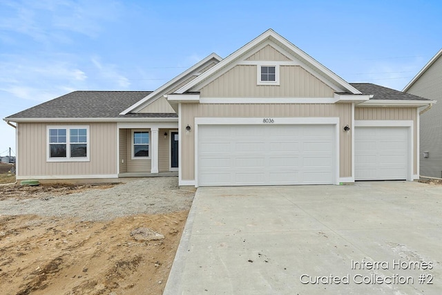 view of front of house featuring driveway, a shingled roof, and an attached garage