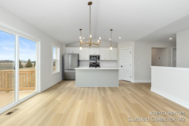 kitchen featuring visible vents, decorative backsplash, stainless steel appliances, light countertops, and white cabinetry