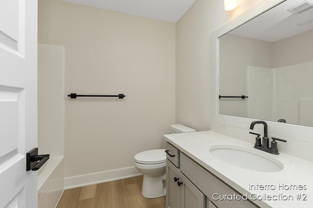 full bath with toilet, wood finished floors, vanity, visible vents, and baseboards