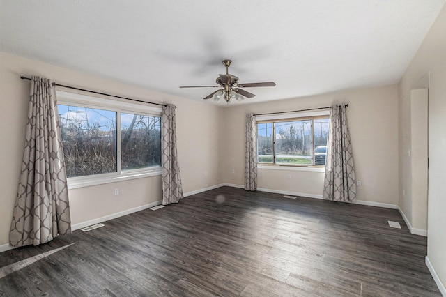 empty room with dark hardwood / wood-style floors and ceiling fan