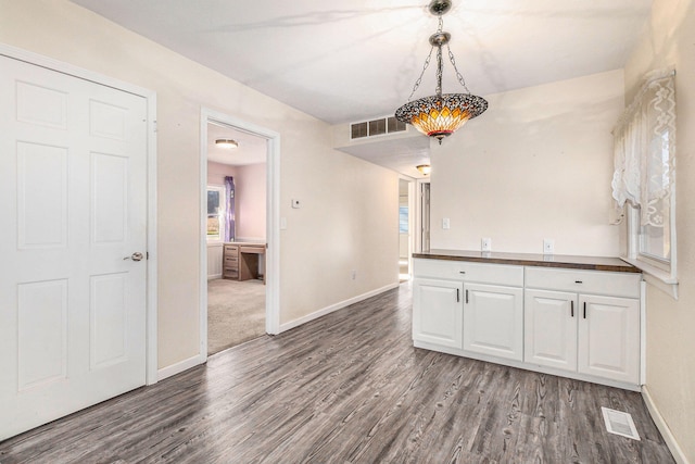 unfurnished dining area with dark hardwood / wood-style flooring