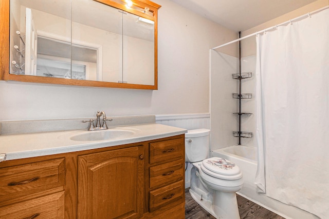 full bathroom with hardwood / wood-style floors, vanity, shower / tub combo, and toilet