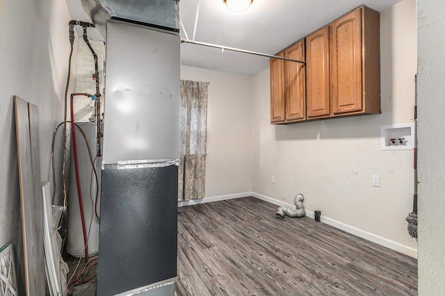 clothes washing area with cabinets, hookup for a washing machine, and wood-type flooring