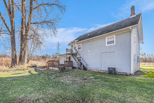 back of house featuring a lawn, cooling unit, and a deck