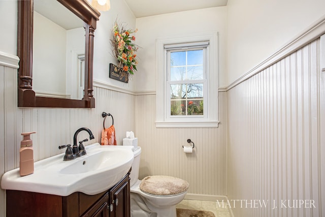 bathroom featuring tile patterned floors, vanity, and toilet