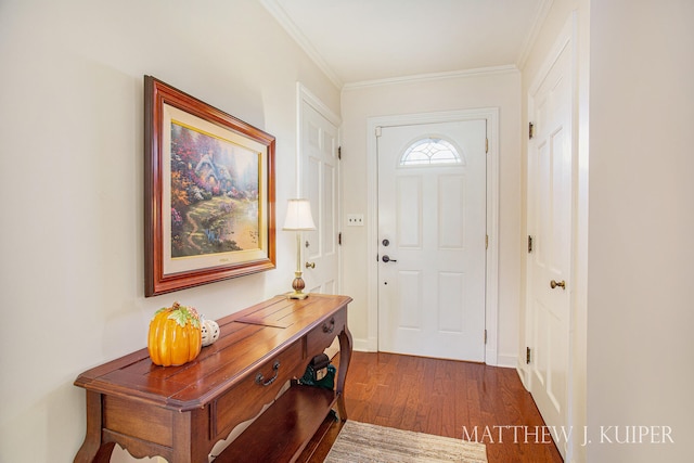 entrance foyer with dark hardwood / wood-style flooring and ornamental molding