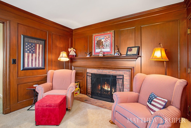 living area featuring light carpet, crown molding, wood walls, and a brick fireplace