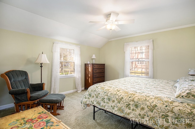 carpeted bedroom featuring multiple windows, vaulted ceiling, ceiling fan, and ornamental molding