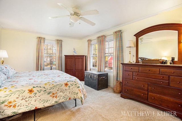 carpeted bedroom featuring ceiling fan, ornamental molding, and multiple windows