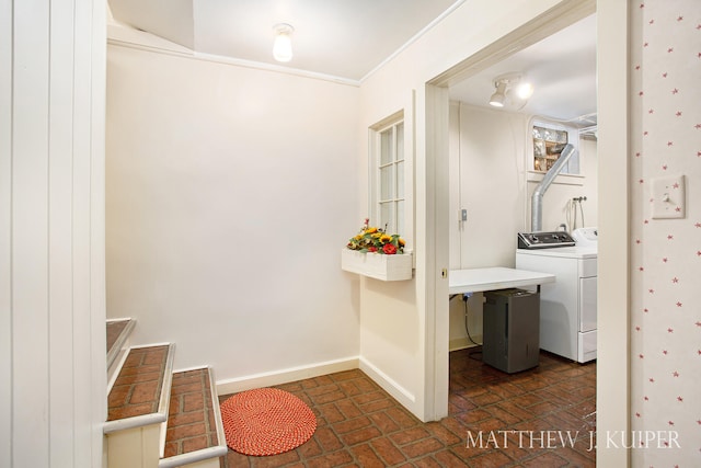 laundry area featuring washer and clothes dryer and crown molding