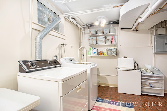 clothes washing area with electric panel and independent washer and dryer