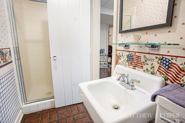 bathroom featuring toilet, sink, and walk in shower