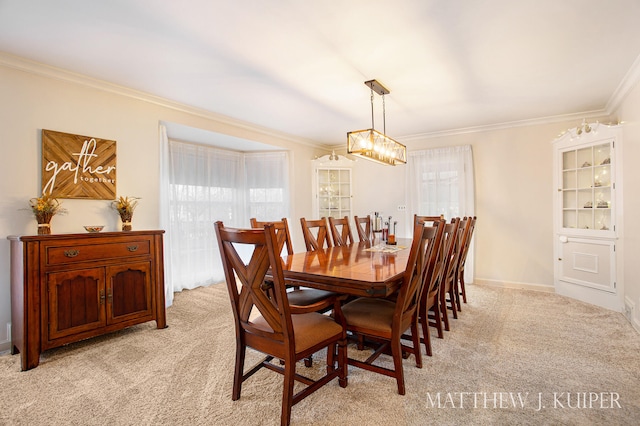 carpeted dining room with an inviting chandelier and ornamental molding