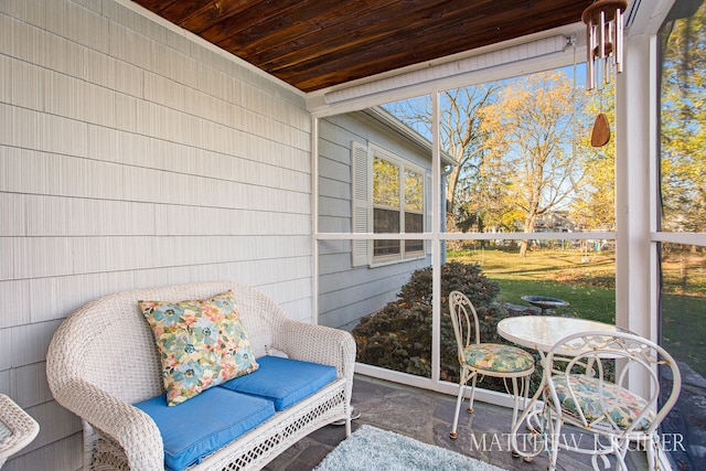 sunroom / solarium featuring wood ceiling