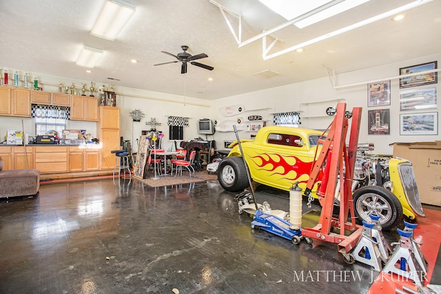 garage featuring a workshop area and ceiling fan