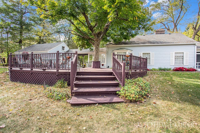 back of house with a deck and a yard