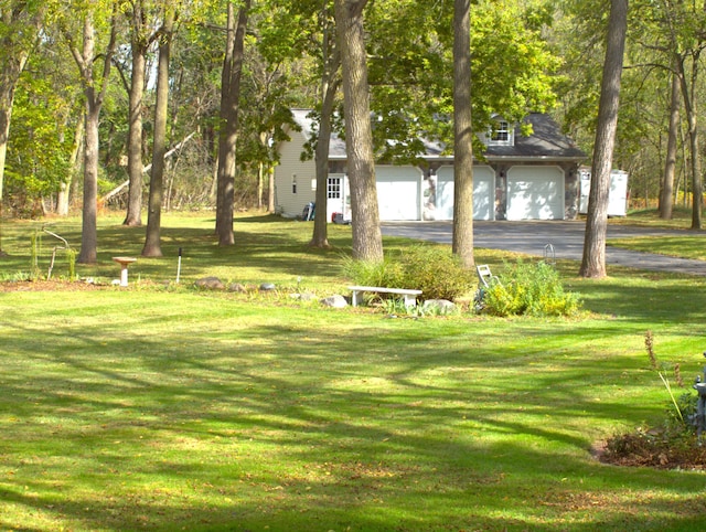 view of home's community with a yard