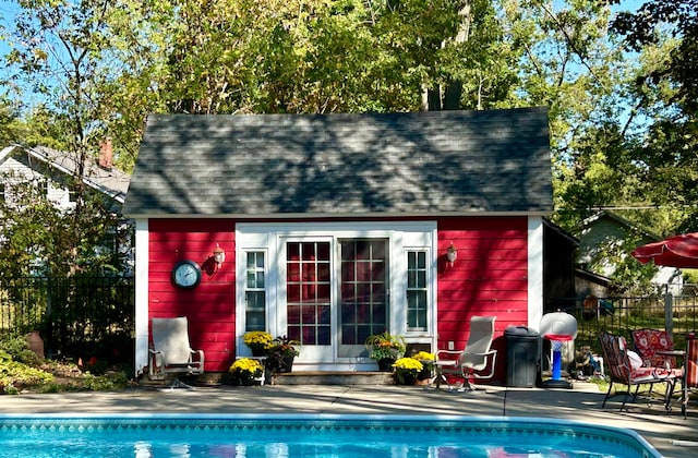 view of outbuilding with a fenced in pool