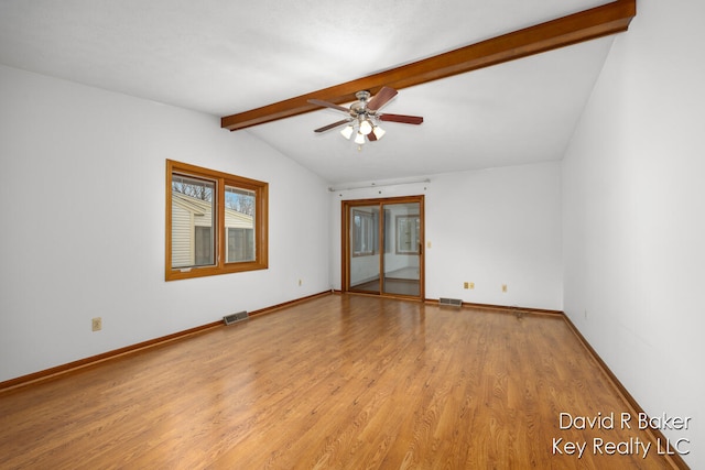 spare room featuring lofted ceiling with beams, light hardwood / wood-style floors, and ceiling fan