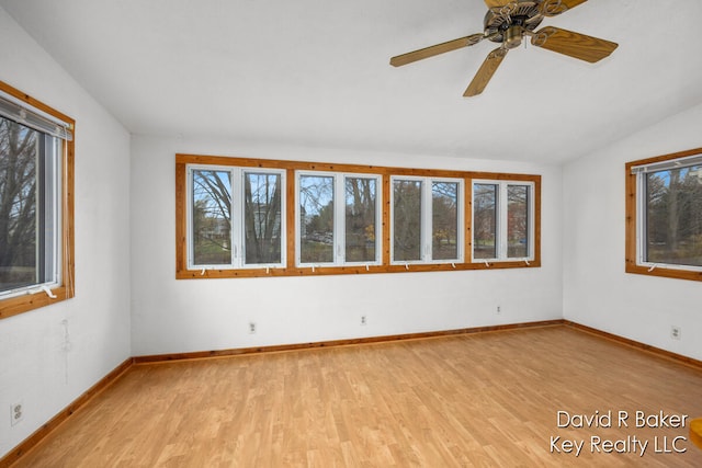 unfurnished room with ceiling fan, light hardwood / wood-style flooring, and lofted ceiling