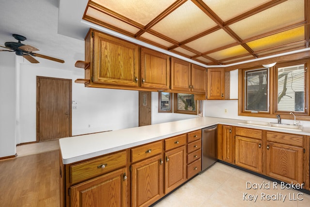 kitchen with ceiling fan, dishwasher, sink, light hardwood / wood-style flooring, and kitchen peninsula