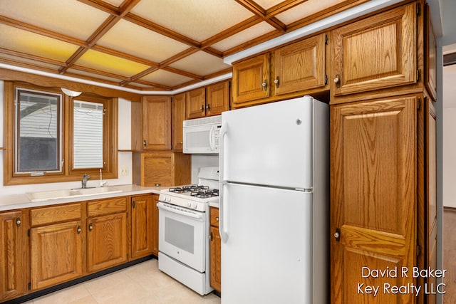 kitchen with white appliances, sink, and coffered ceiling