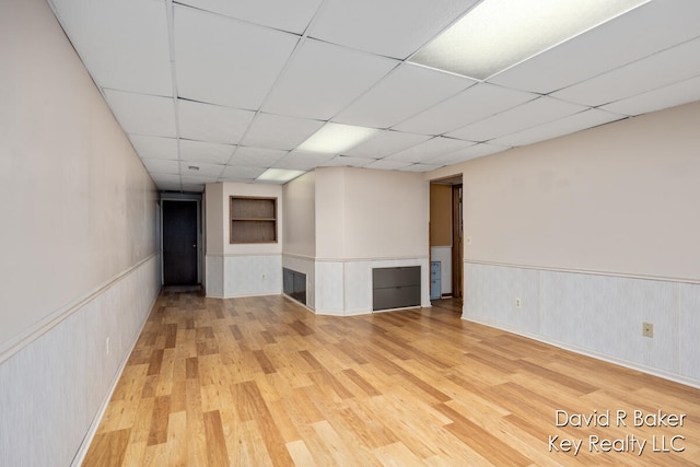 empty room with hardwood / wood-style floors and a paneled ceiling