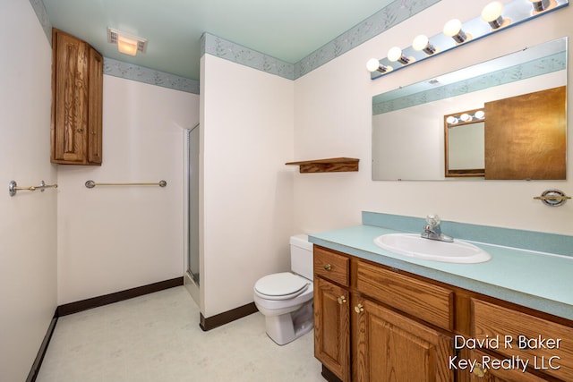 bathroom with vanity, toilet, and an enclosed shower