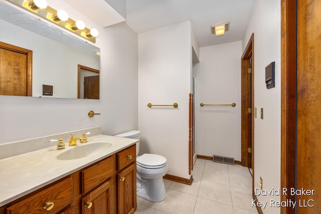 bathroom with tile patterned floors, vanity, and toilet