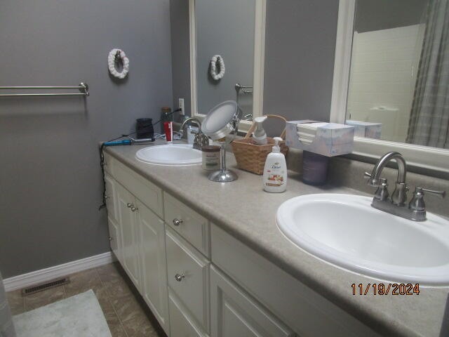 bathroom with tile patterned floors and vanity