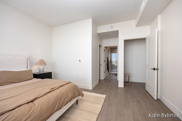 bedroom featuring light wood-type flooring and baseboards