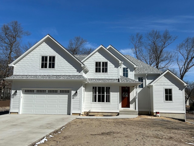 view of front of home featuring a garage, a shingled roof, and concrete driveway