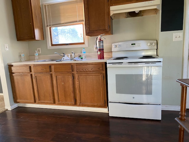 kitchen featuring sink, dark hardwood / wood-style flooring, and white electric stove