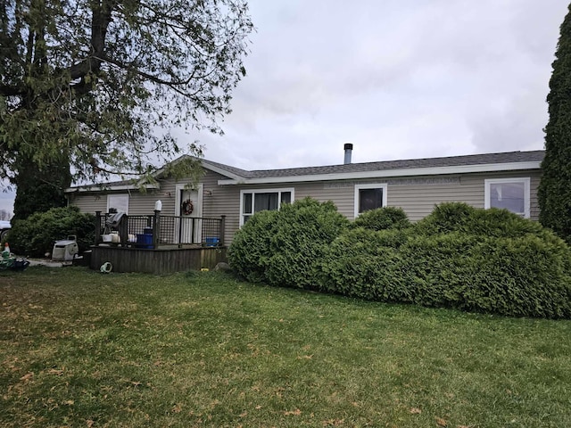 back of house with a yard and a wooden deck