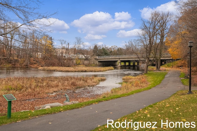 view of property's community featuring driveway and a water view