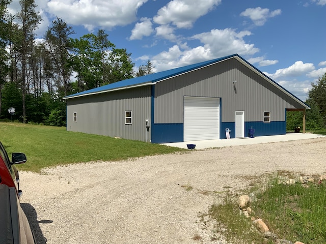 view of outbuilding with a lawn and a garage